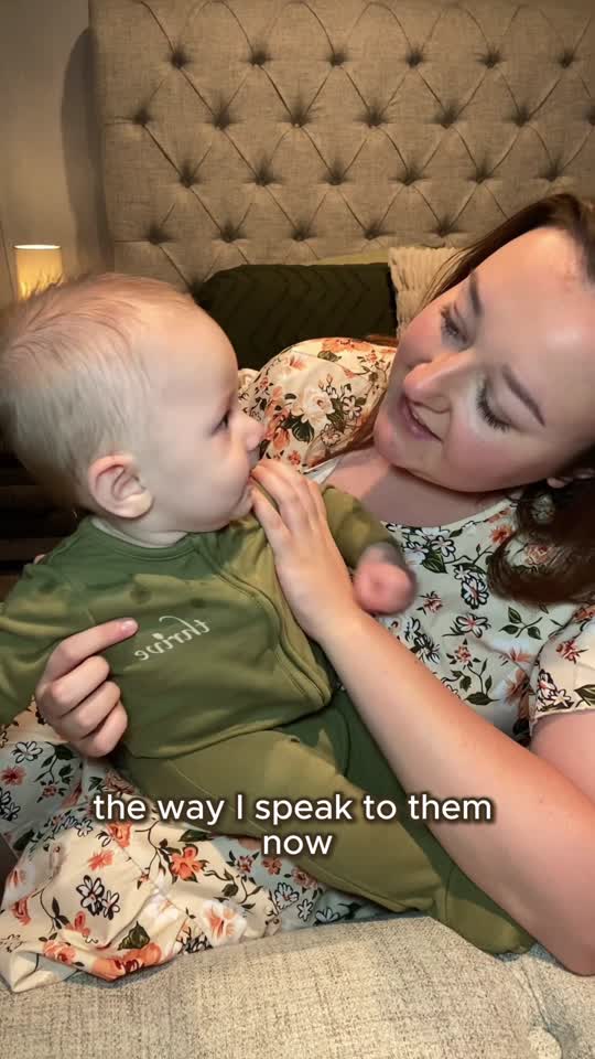 Mother holding her baby in a green SAĒD Thrive garment